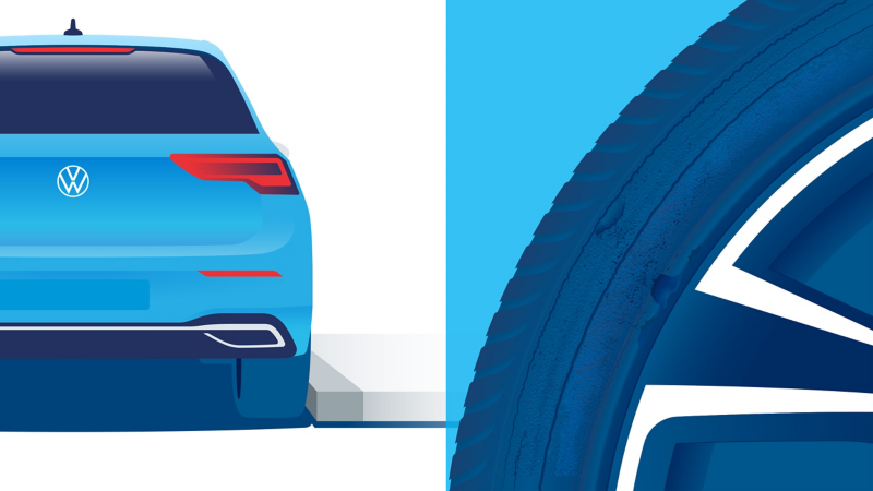 VWのサービススタッフがVWのタイヤに損傷がないかチェックしている