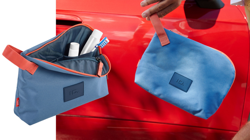 Accessoire-Tasche aus der ID. Kollektion von Volkswagen Zubehör, im Hintergrund ein VW ID.5