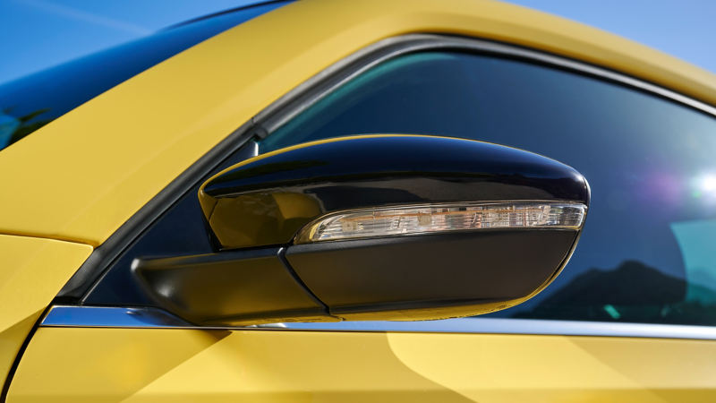 Close-up exterior mirror cap of a VW Beetle
