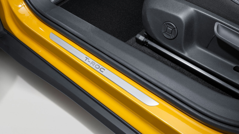 VW Accessories door sill trims with vehicle lettering on the yellow T-Roc