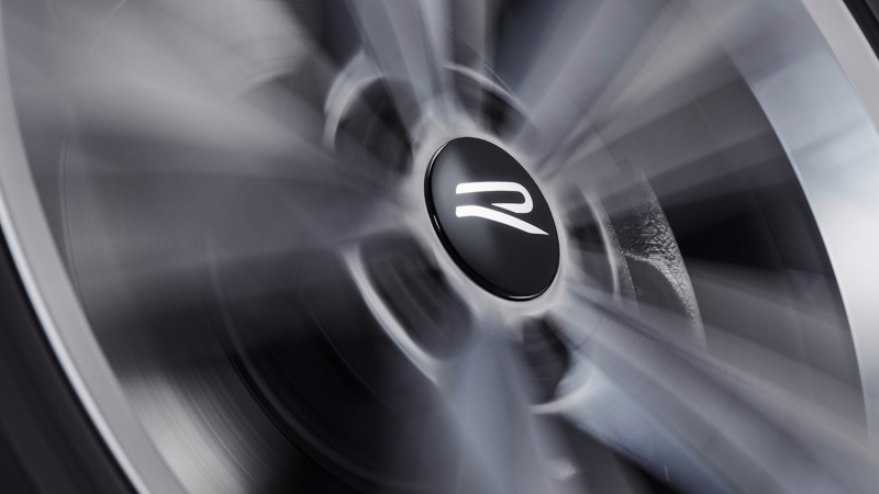 Dynamic hub cap by VW Accessories with the “R” logo on a spinning wheel