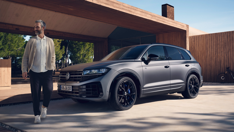 Man walking next to Touareg