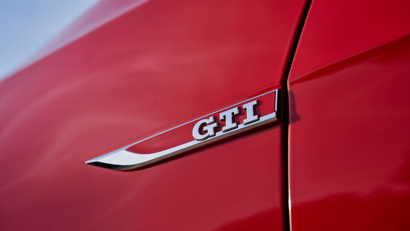 Close-up of the “GTI” logo on a VW car