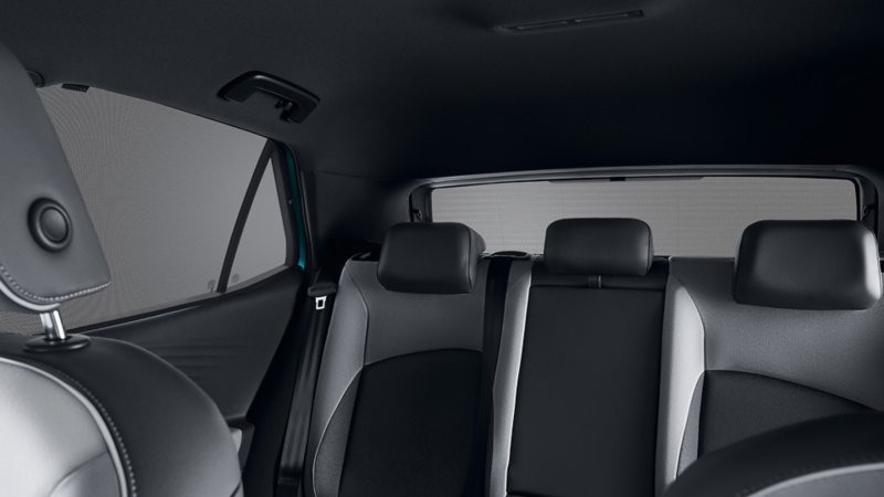 View of back seat bench of VW vehicle, VW Accessories sun blinds on side and rear window in focus