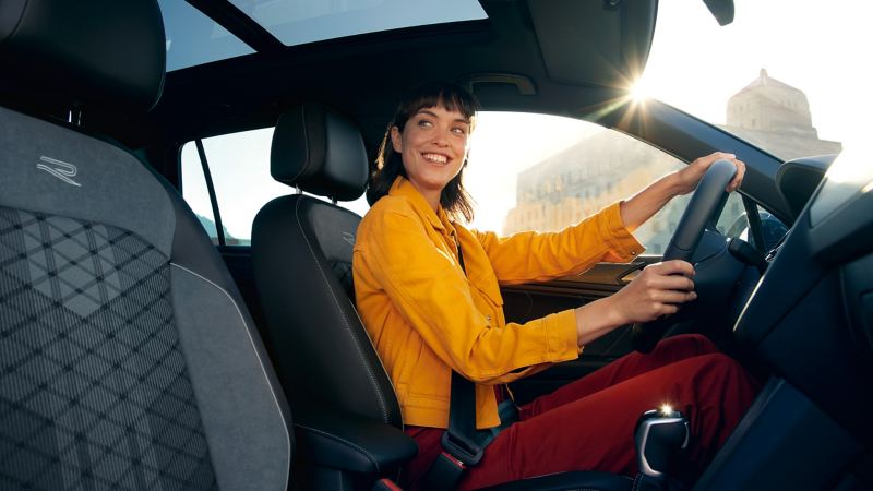 A woman sits at the wheel of her Tiguan R-Line