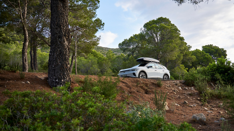 VW ID.4 with roof box by VW Accessories on idyllic country road