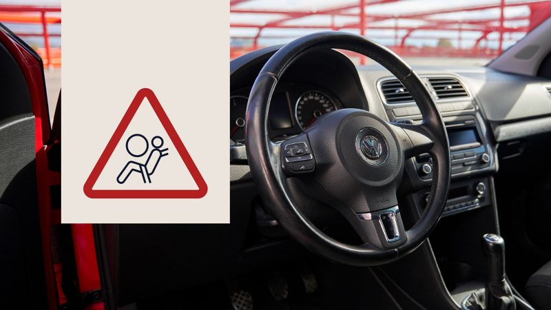 Warning symbol for airbag risk in front of steering wheel inside VW car