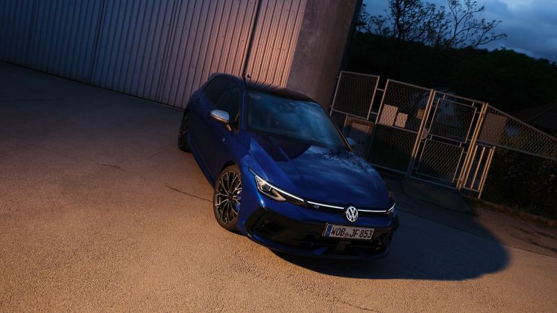 VW Golf R in front of a factory building