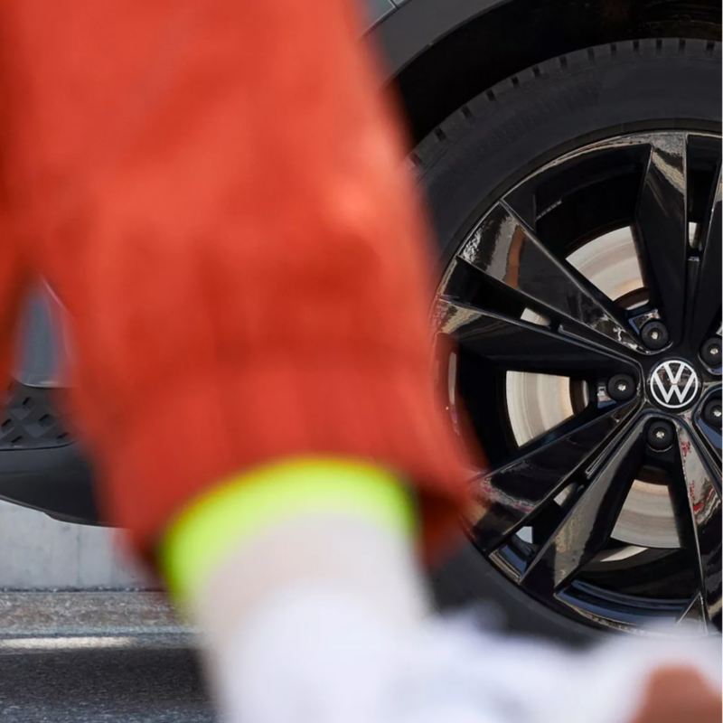 Person walking in front of VW wheel.