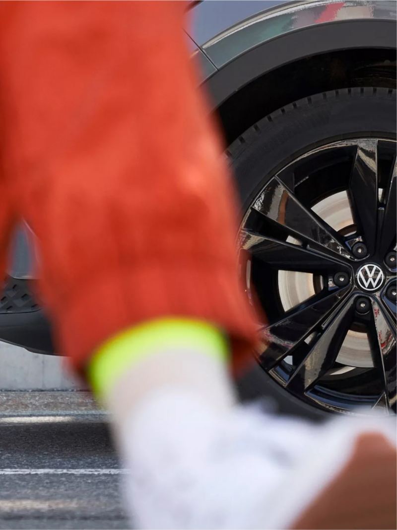 Person walking in front of VW wheel.