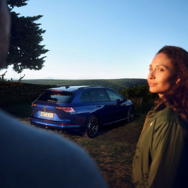 VW Golf R Variant mit Blick auf das Meer, im Vordergrund eine Frau