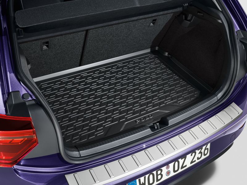 A white VW car with open luggage compartment and tennis equipment inside – Volkswagen Accessories luggage compartment solutions