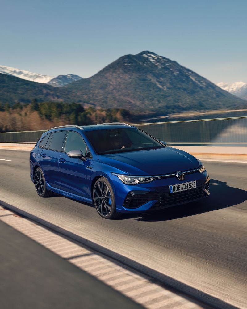 The VW Golf R Estate in Lapiz Blue driving along a mountain road