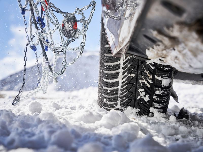 Detailed view of a VW winter tyre with Volkswagen Accessories snow chains