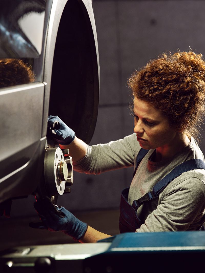 Frau arbeitet an einem VW - Volkswagen Wartungsverträge