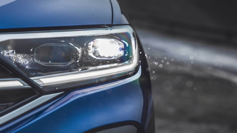 A man stands at the door of his VW T-Roc R