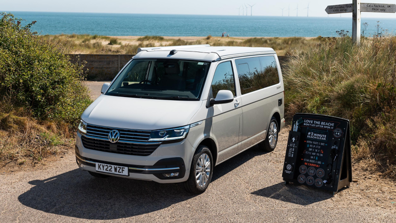 A VW California 6.1 Ocean parked on a beach. 