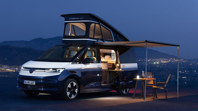 Volkswagen California Concept parked with roof extended and camping set up 