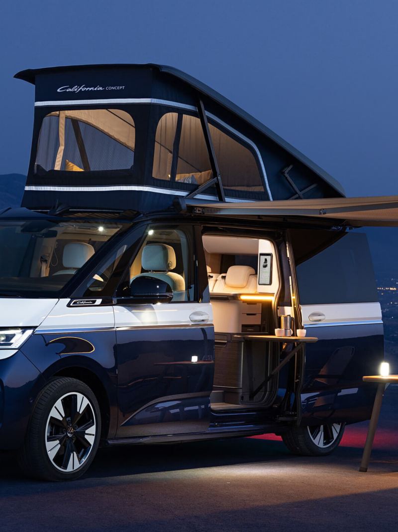 Volkswagen California Concept parked with roof extended and camping set up 