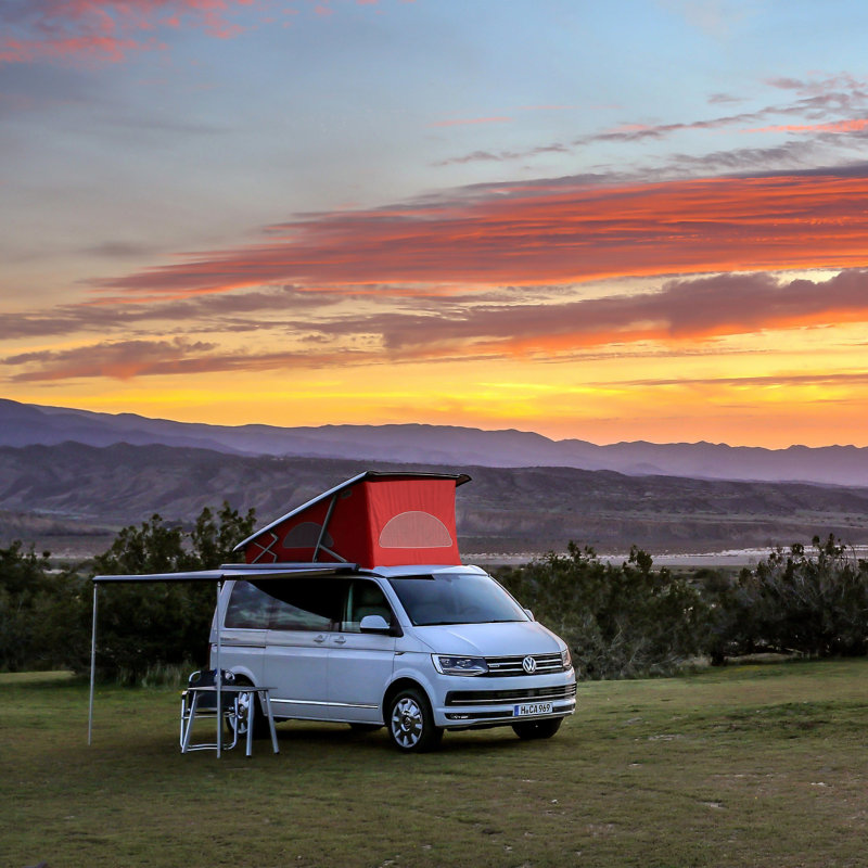 VW California parked under orange evening sunset