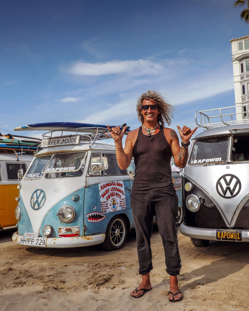 Surfer in front of vintage VW Camper