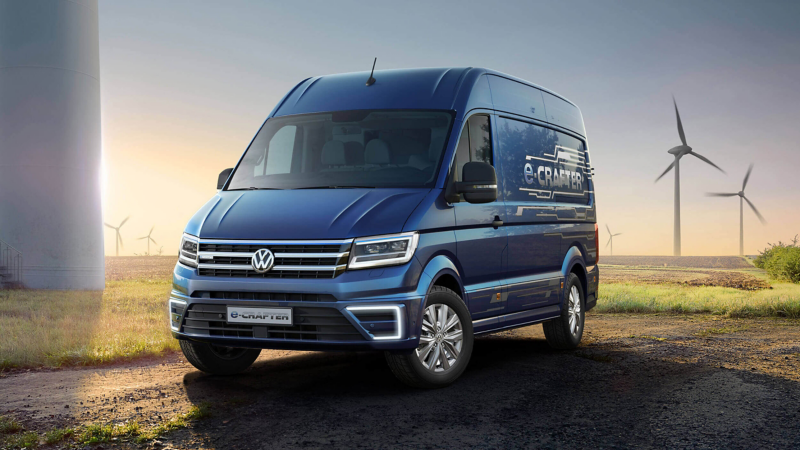 Volkswagen electronic crafter on a countryside road next to wind turbines