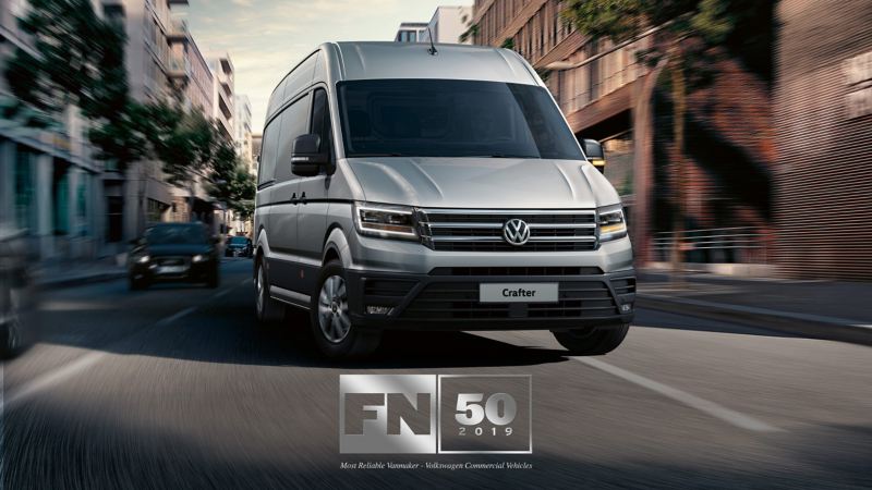 VW Crafter panel van in city with FN50 awards logo 