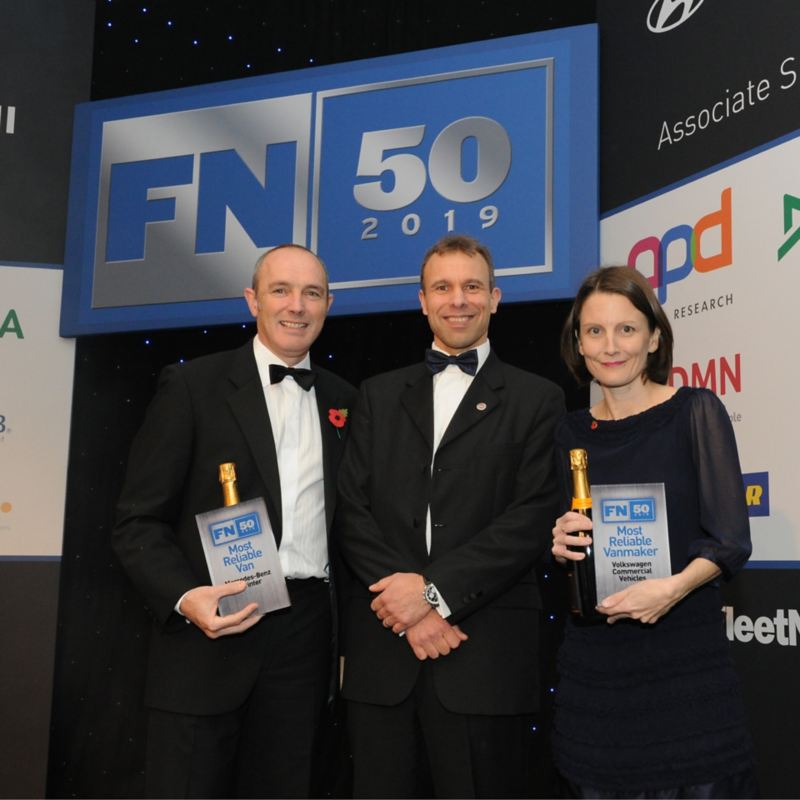 Fleet News editor and Volkswagen staff with awards during ceremony