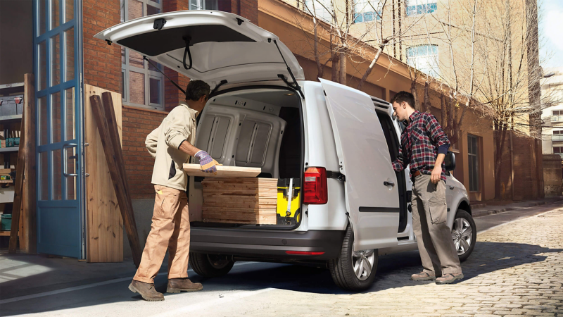 Workmen securing load in a VW Caddy van