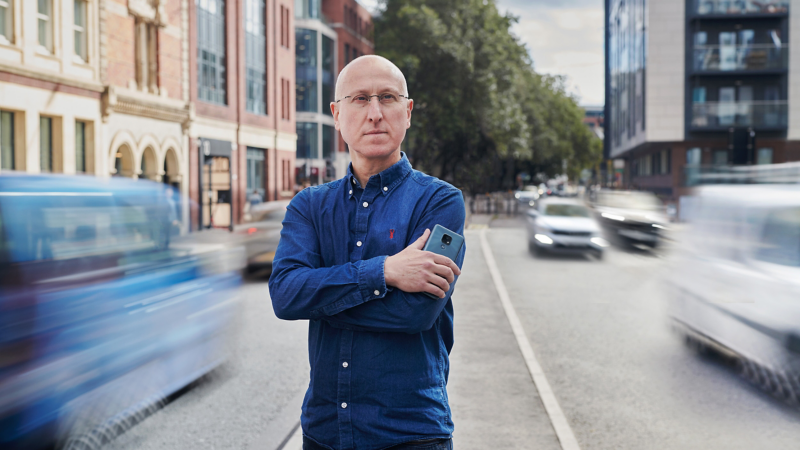 Ben Lane, co-founder of Zap-Map standing proudly in the middle of a busy road. 