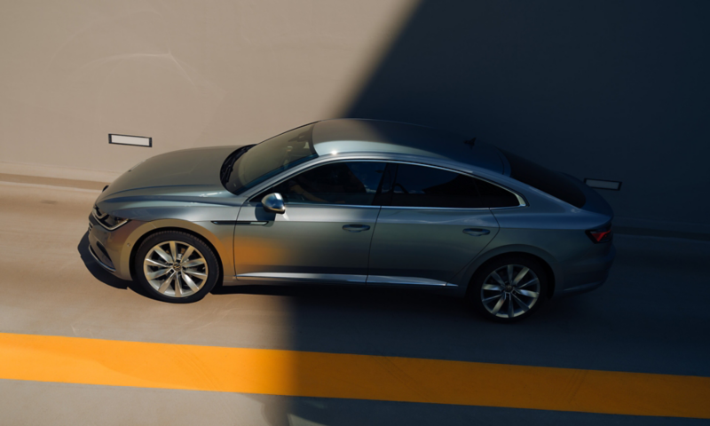 VW Arteon Hybrid drives past at the side