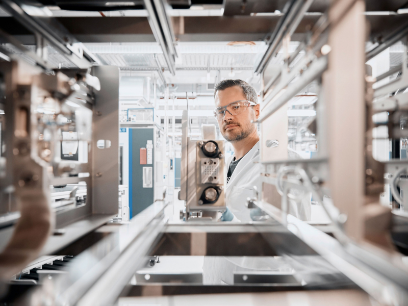 Man working in factory looking towards camera
