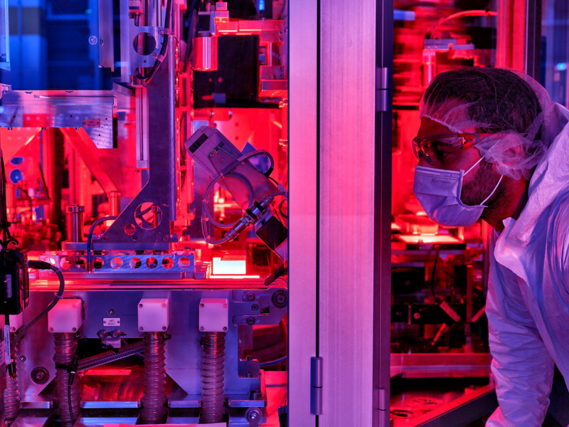 Man looking in factory with red lighting