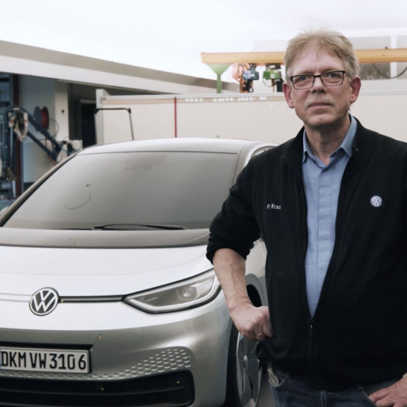Volkswagen's Peter Kraus in front of a car.