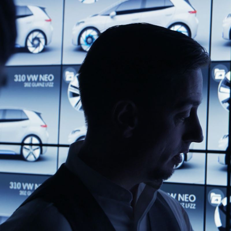 Volkswagen's Klaus Bischoff standing front of a video wall showing the ID.3
