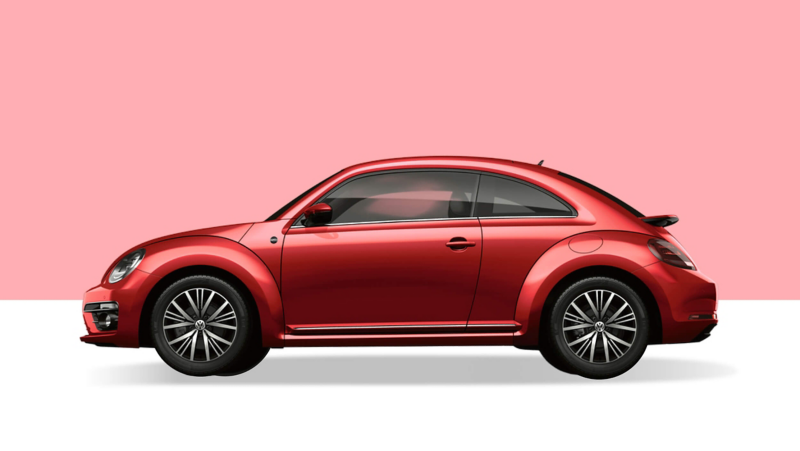 Side view of a red VW Beetle on a light red background