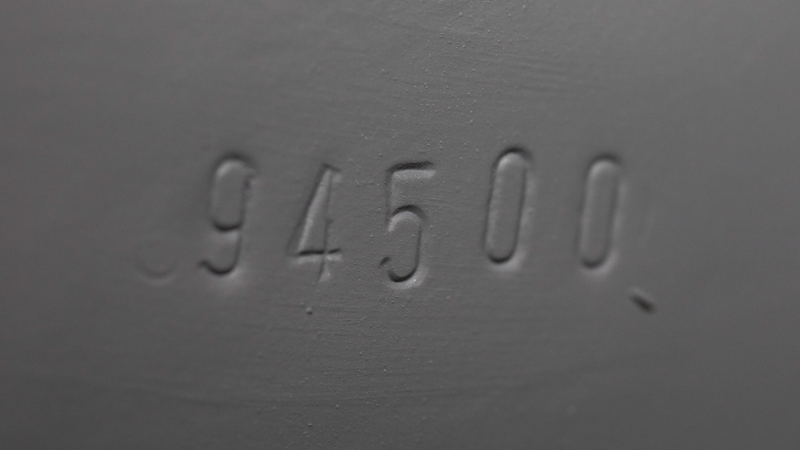 Photo showing a closeup of the body number stamp on a VW Samba van. 