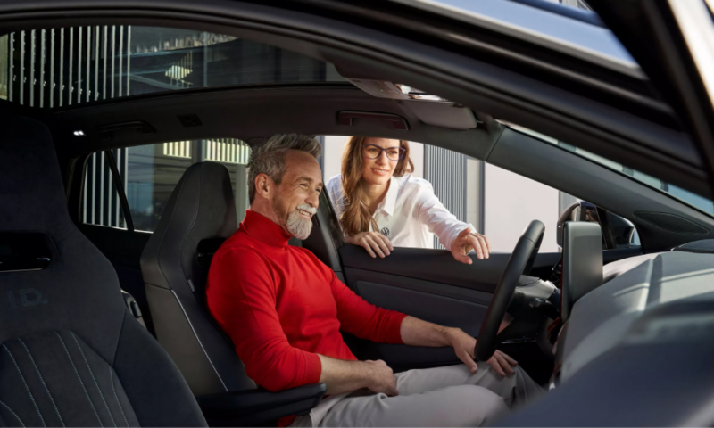 Man in electric getting assistance using infotainment system.