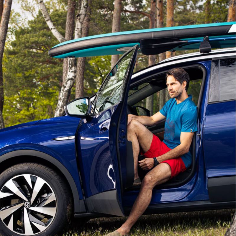 Man seated in blue VW ID.4.