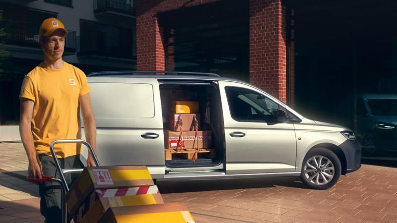 A worker unloading a Transporter 6.1 van