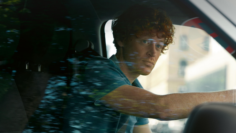 Photo showing a driver inside the cockpit of a VW van. 