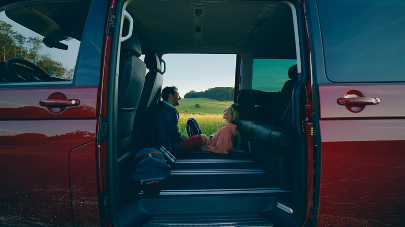 A couple sat inside a Carravelle with the doors open