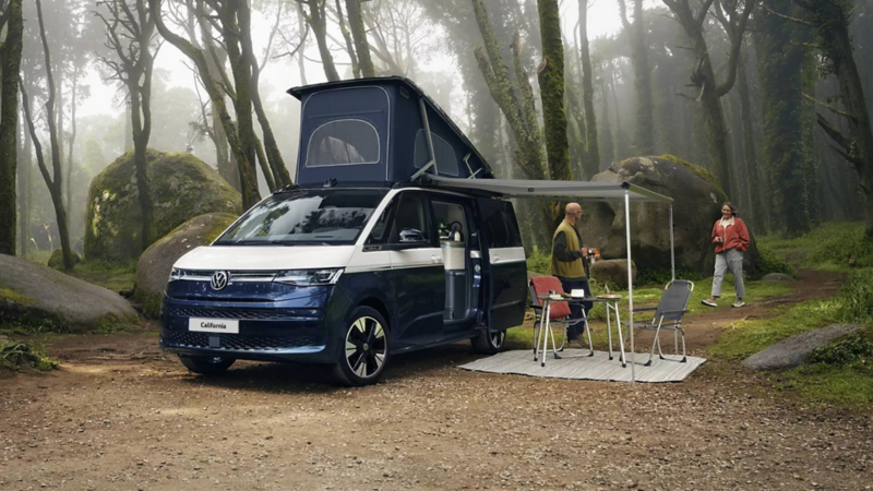 California parked in a forest with the awning and dining accessories deployed.