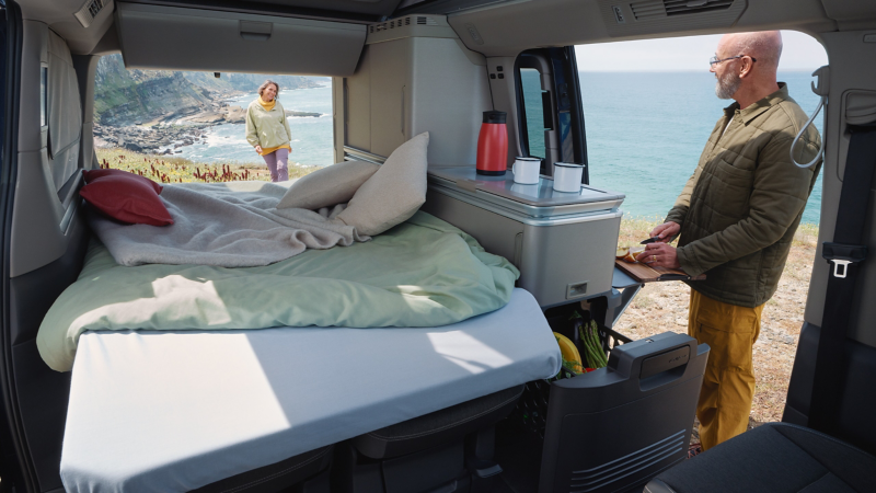 VW camper van with a bed and kitchen.