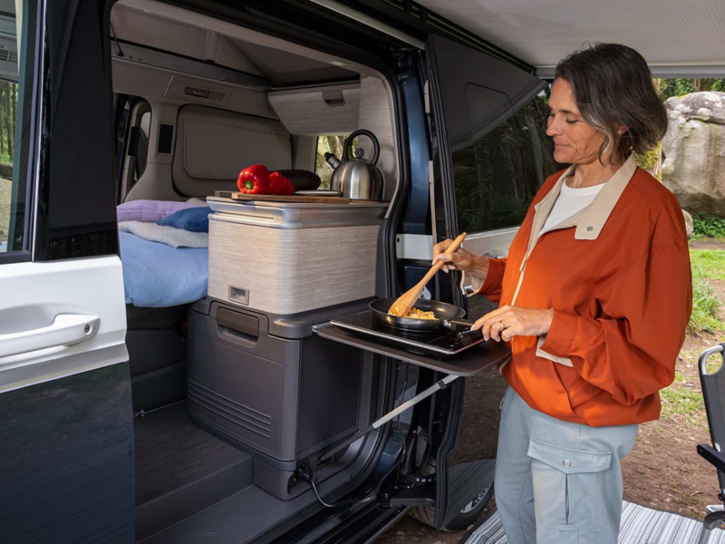 A woman cooking under the California awning. 