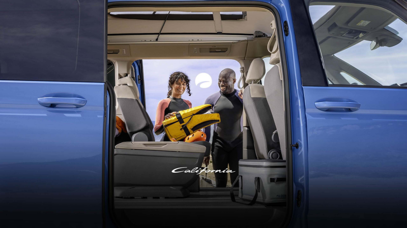 People unloading camping equipment from the van 