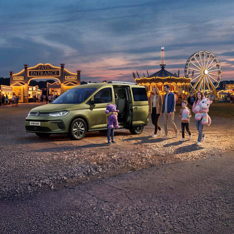 a family getting into their green Caddy and leaving the fairground