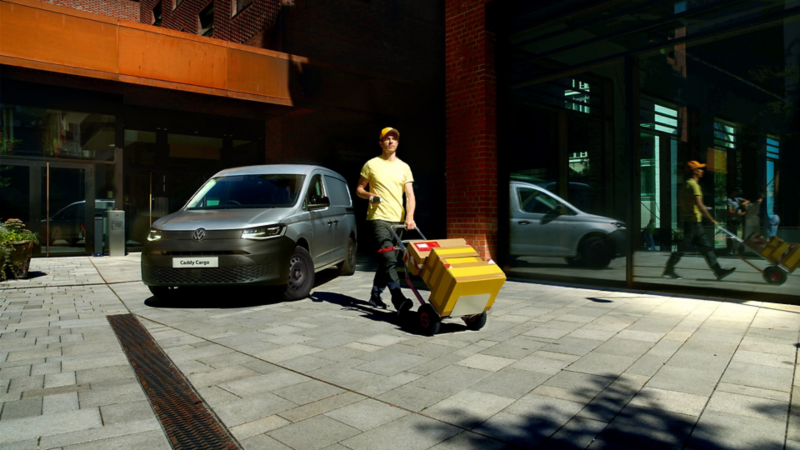 The new Caddy in front of a building complex.