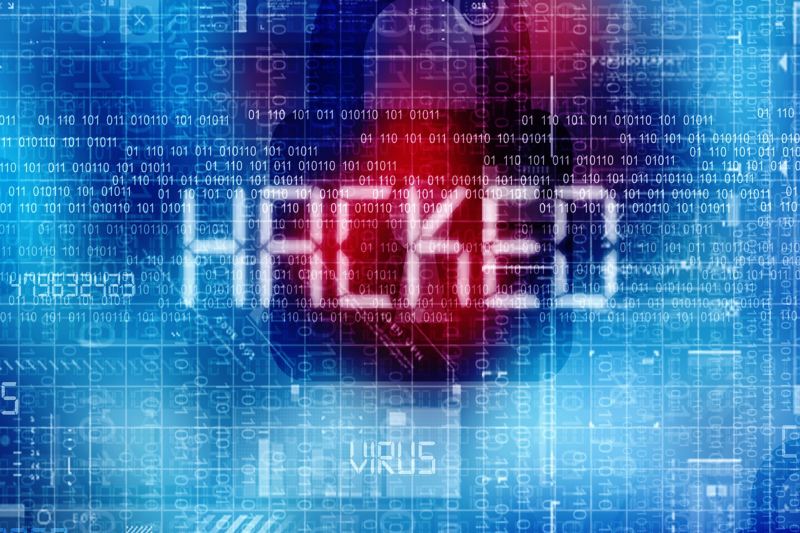 Das Wort Hacked ist in einer Art Computerschrift auf einem collagenartigen Hintergrund zu lesen.