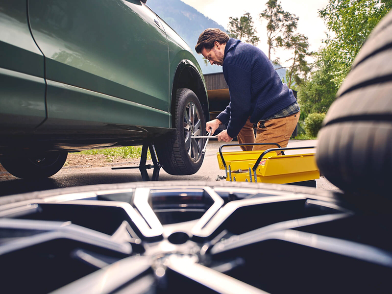 A VW technician checking a wheel 